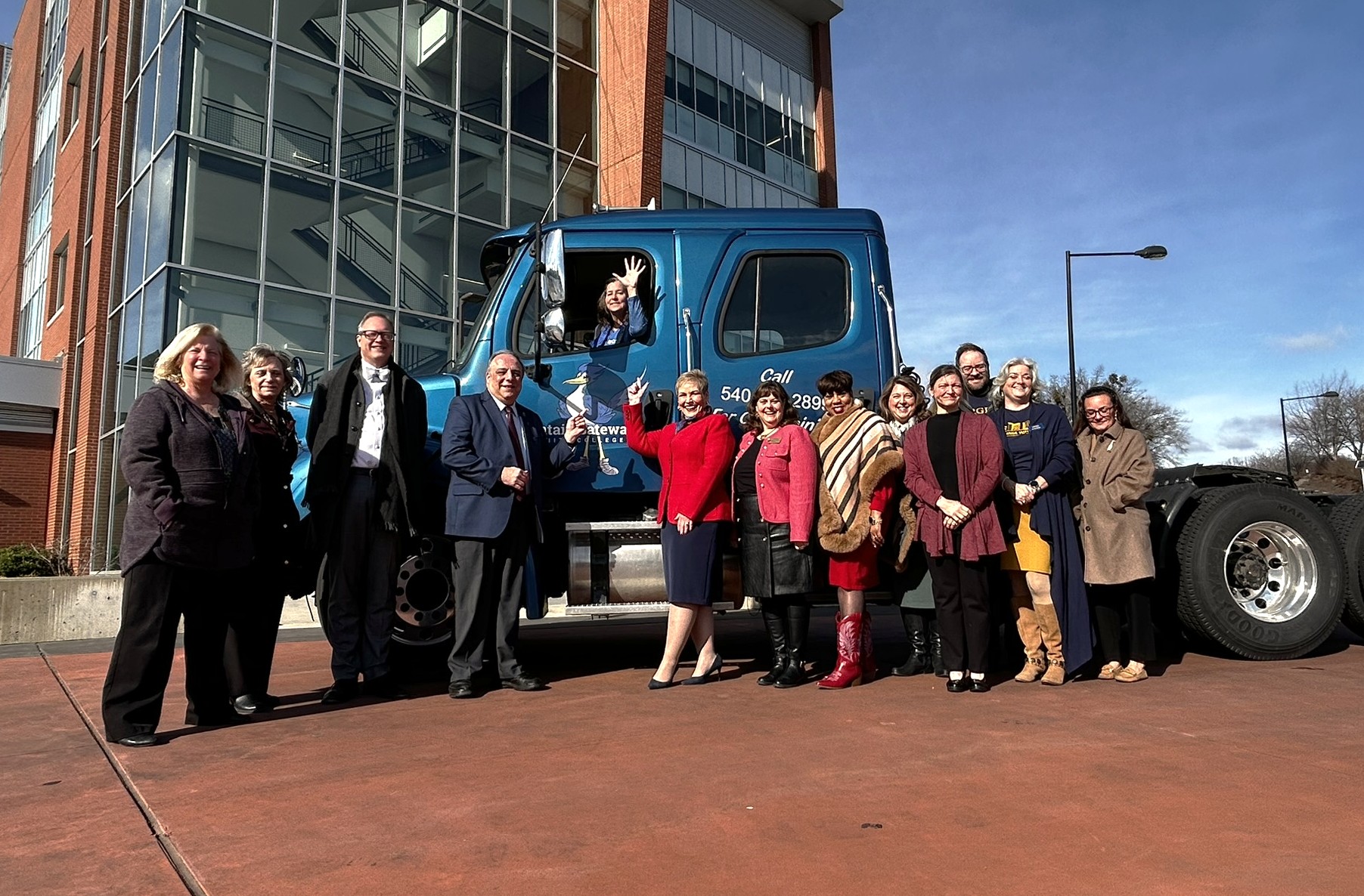 Mountain Gateway and Virginia Western presidents and staff pose in front of a CDL training truck after the signing ceremony