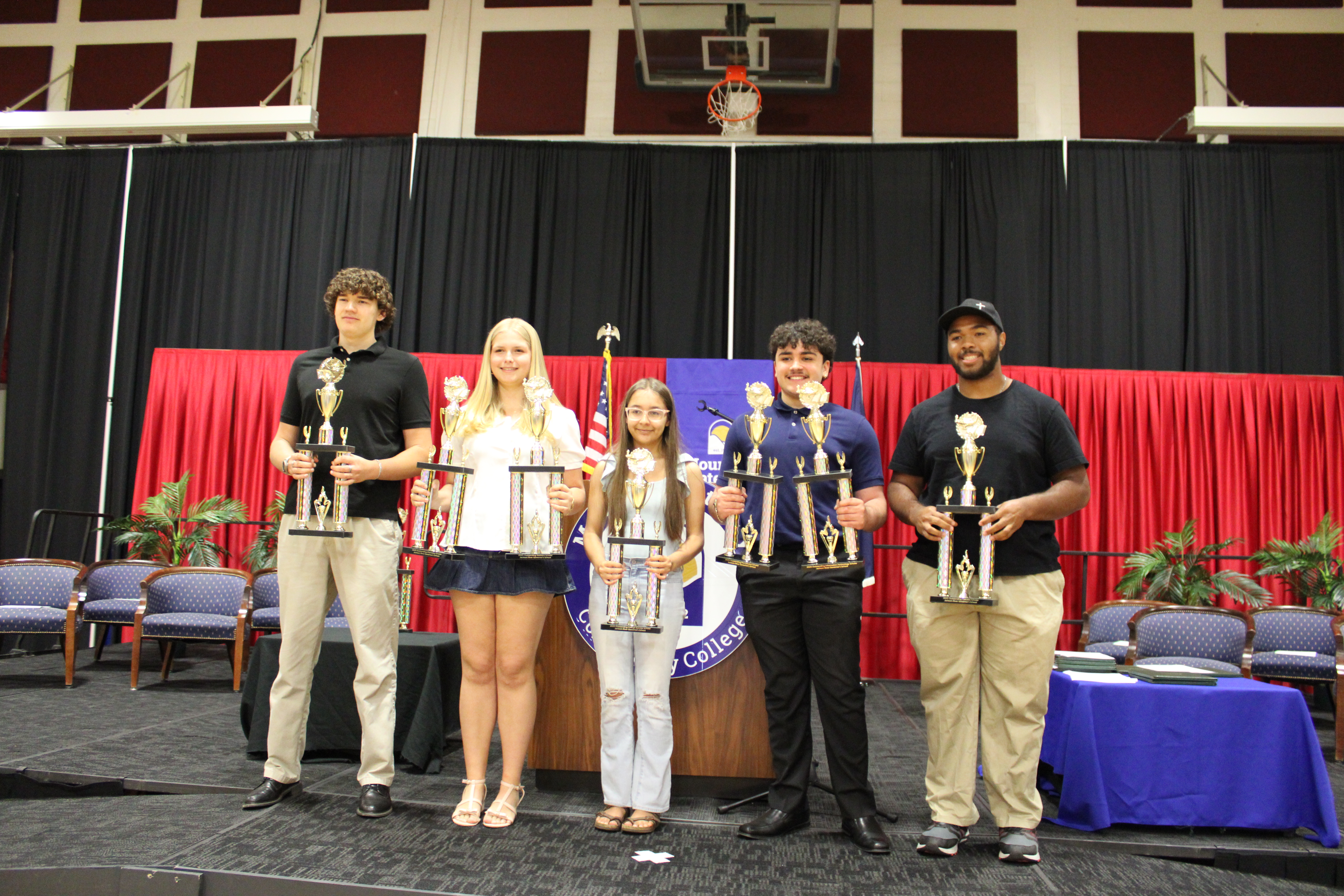 Outstanding Scholars (with trophies) from left: Dylan Tyree, Physics, Kathryn Johnson, Chemistry and Statistics; Olivia Gentry-Delgado, College Success Skills; Dominic Brown, Precalculus and Information Technology; and Rayshan Richardson, Calculus. Absent from photo: Cadiz Marshall, Research.