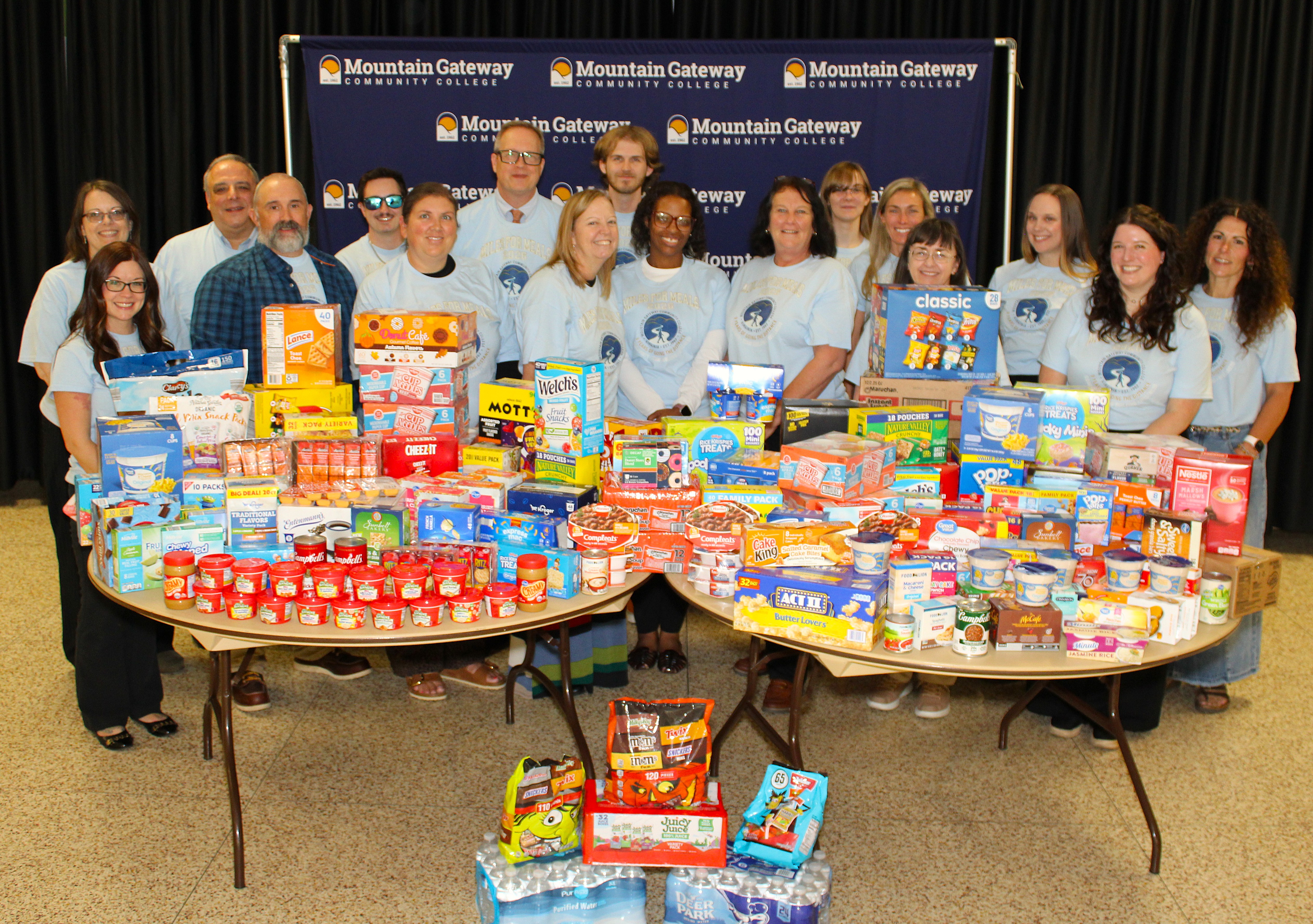 picture of the Miles for Meals participants with donated food items