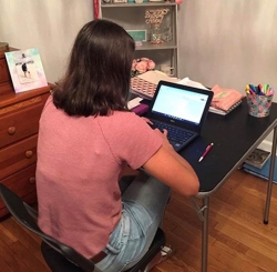 Abby Martin working at her computer