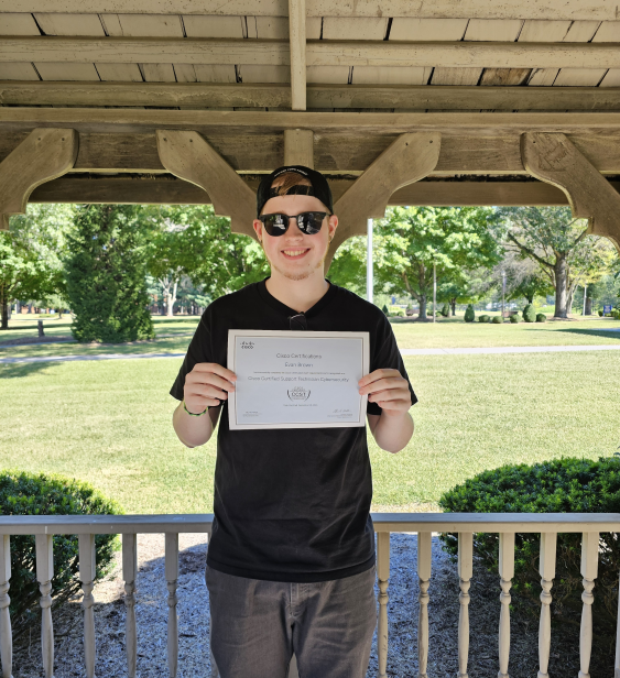Student holding award