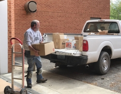 Ted Wiseman Loads food donations into truck