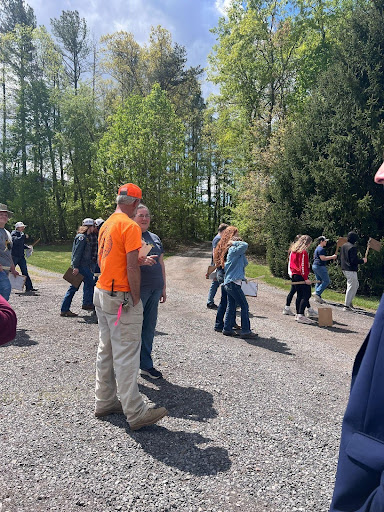 Man in high vis talking to student