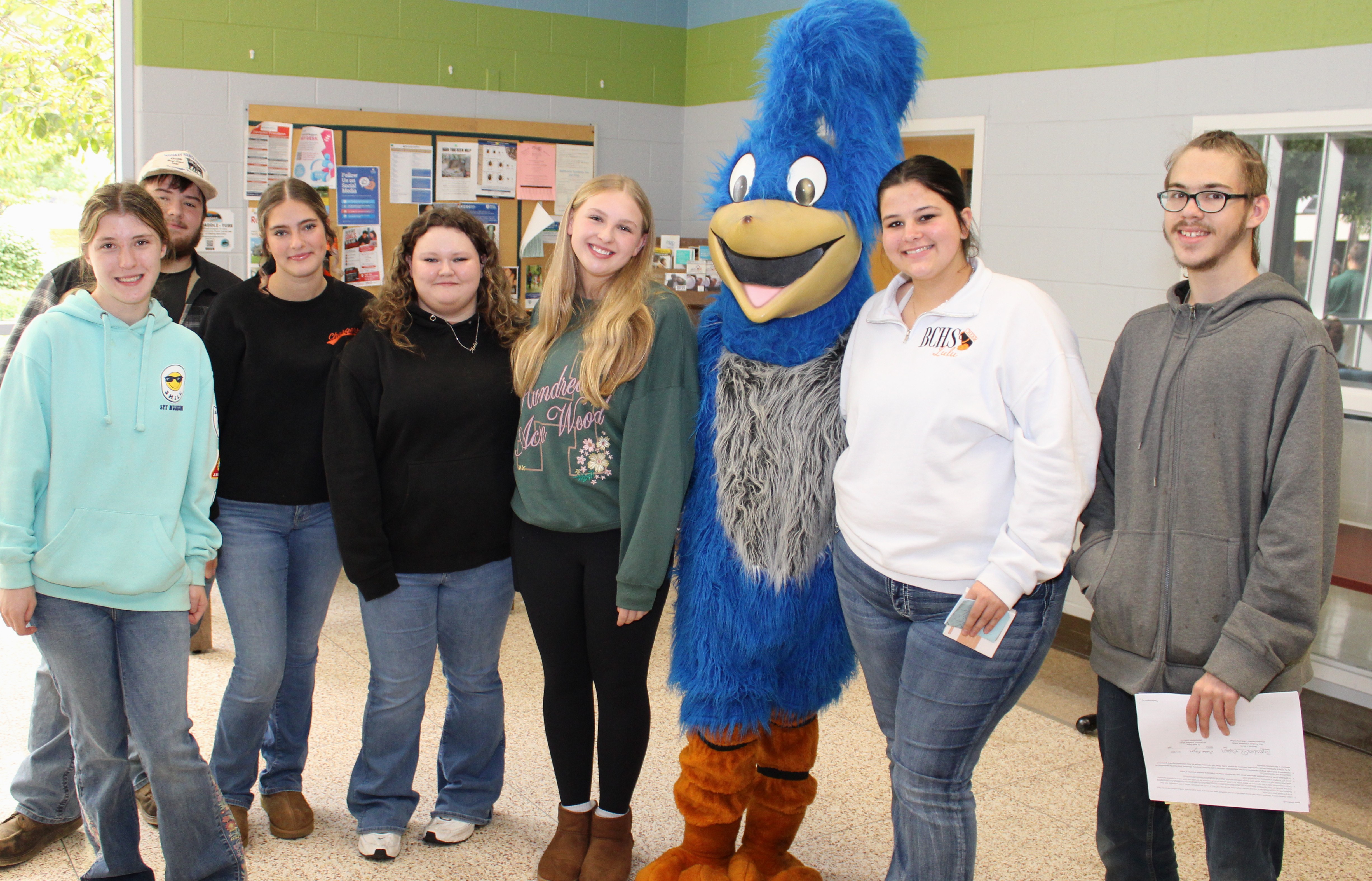 Area high school students posing with Roadie during MGCC Roadrunner Days